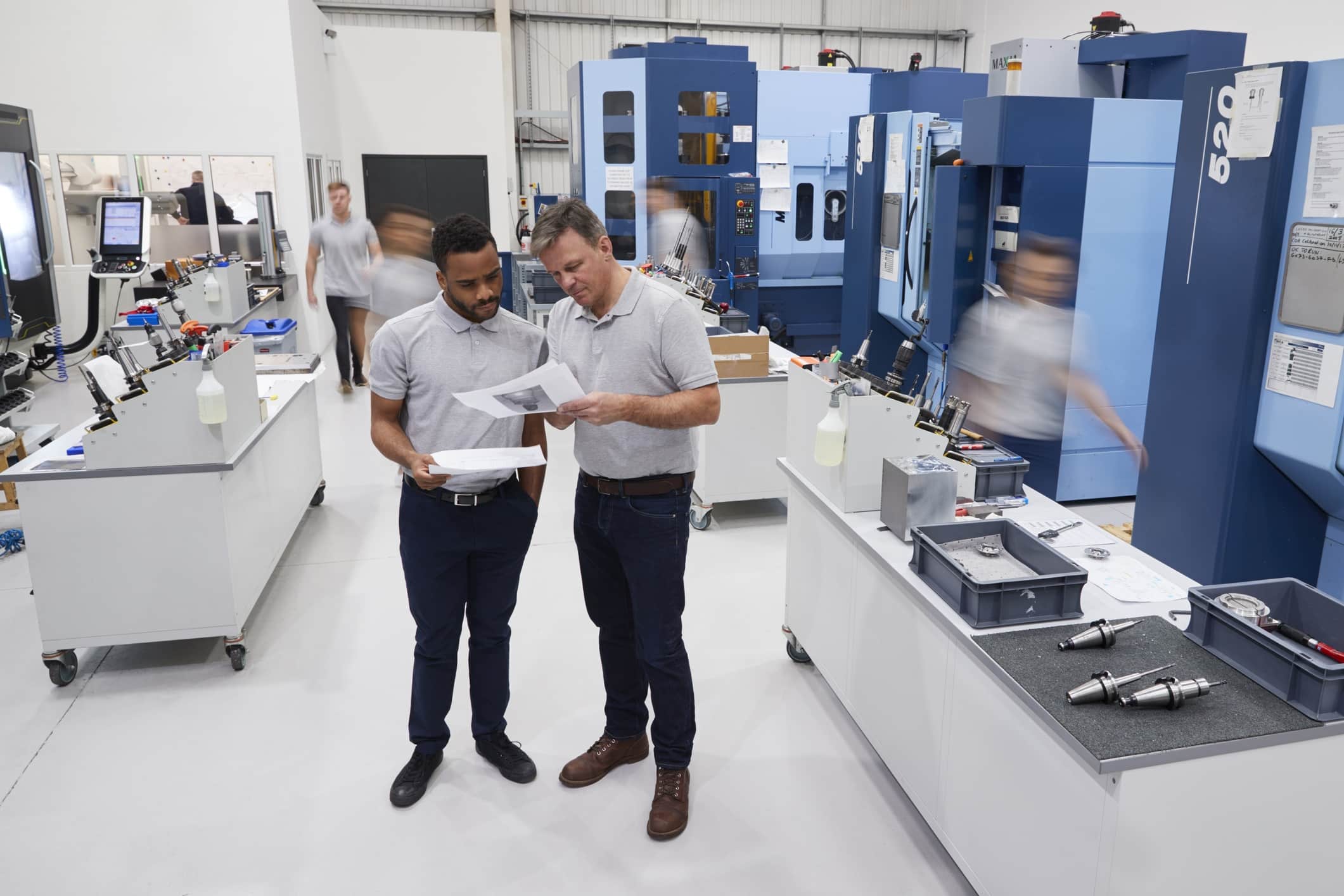 Process improvement image of workers in office reviewing papers