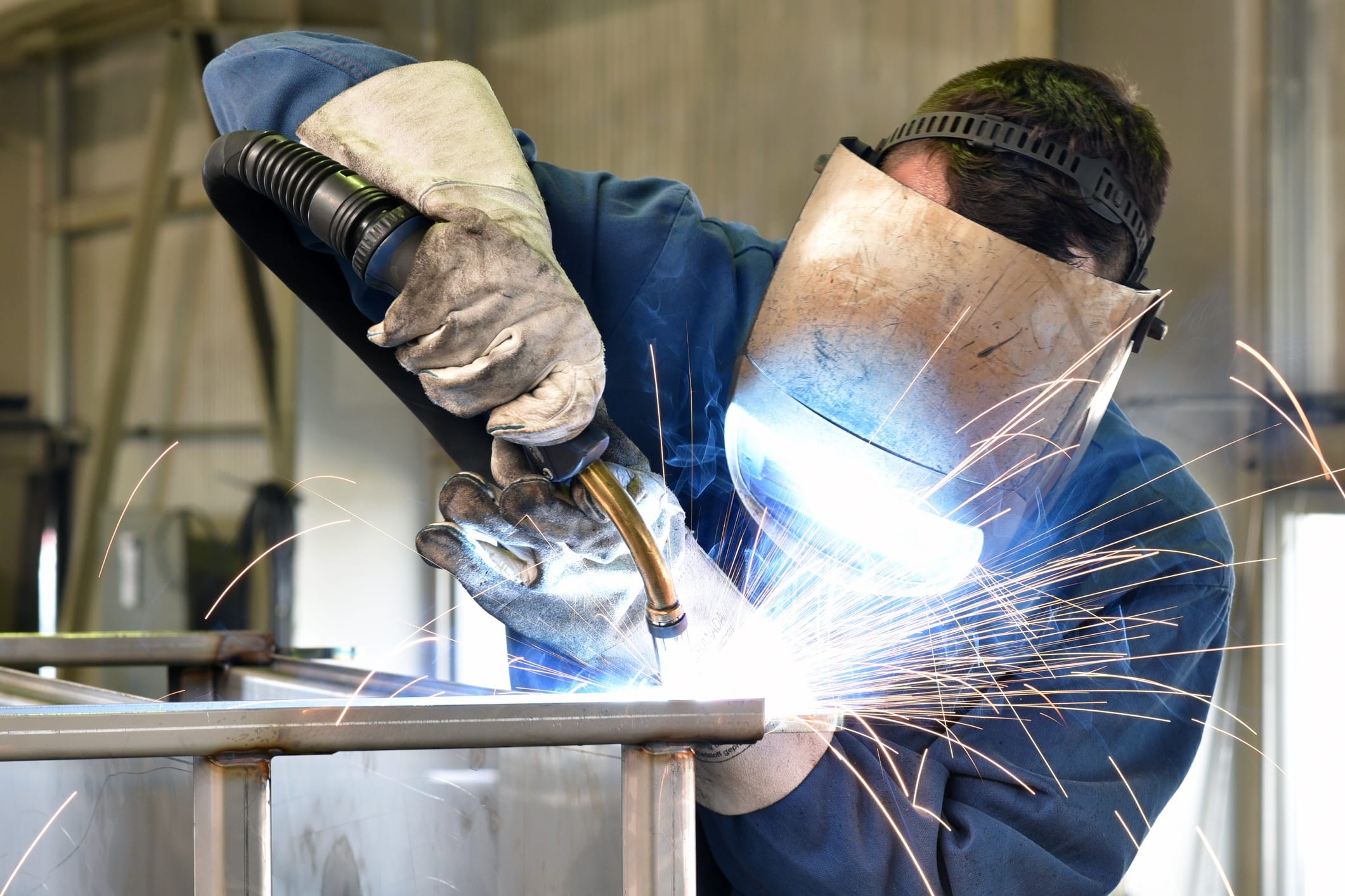 Welder welding with sparks flying